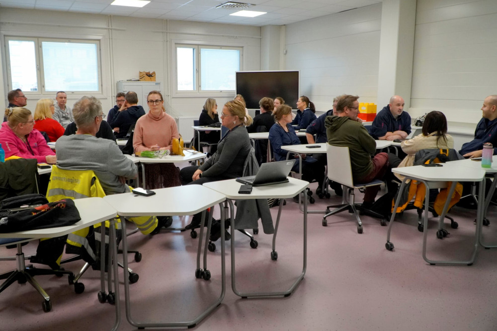 People sitting and discussing in a class room